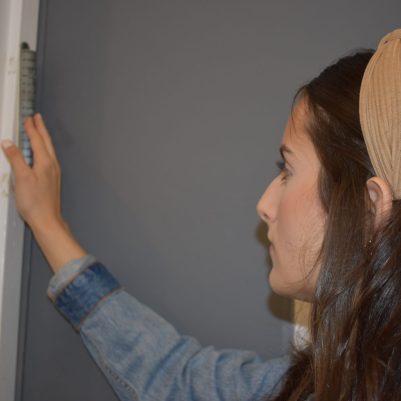 Woman touching mezuzah 2