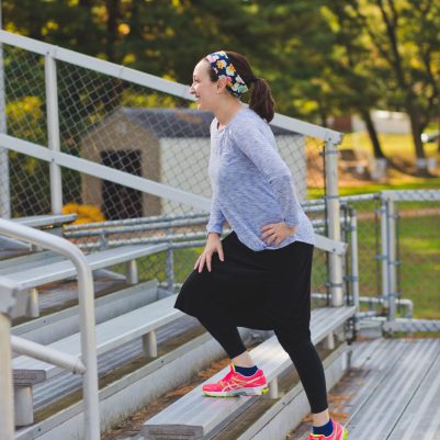 Woman stretching on bleachers