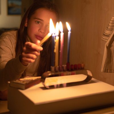 Girl lighting chanukkia 1