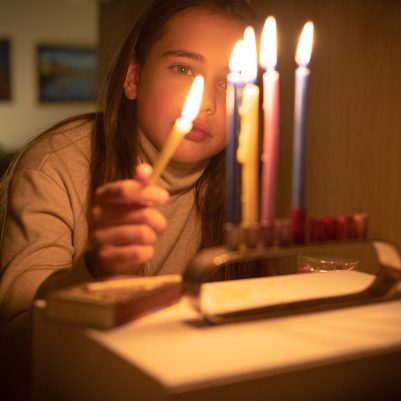 Girl lighting chanukkia 2