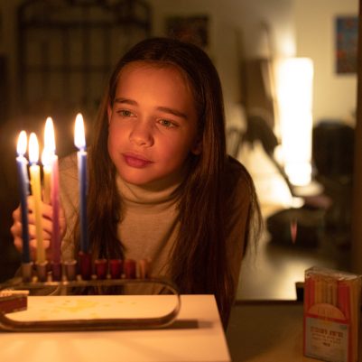 Girl lighting chanukkia 3