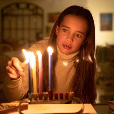 Girl lighting chanukkia 4