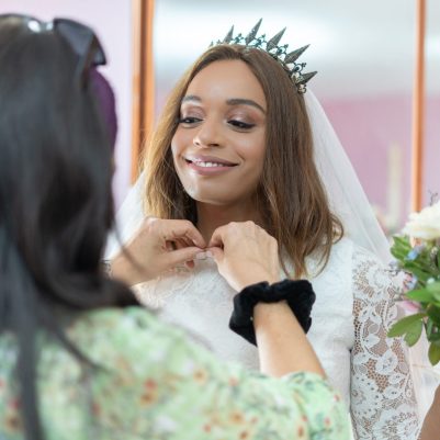 Bride putting on jewellery