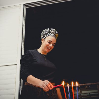 Woman lighting chanukkia 2