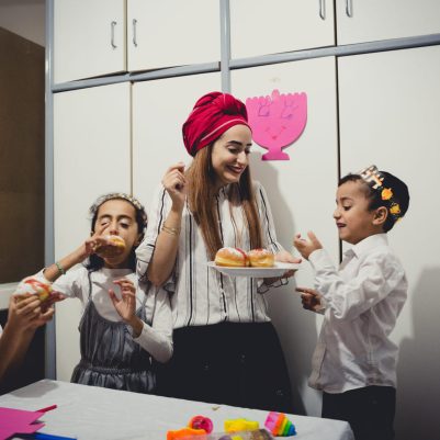 Mother and kids eating sufganiyot 1