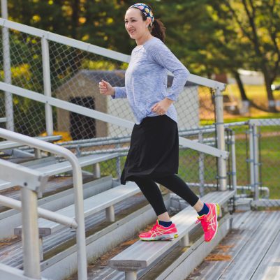 Woman running on bleachers