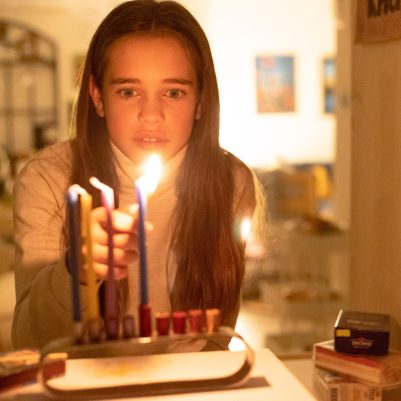Girl lighting Chanukkia 5