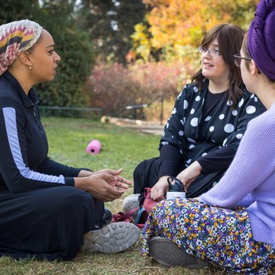 Group of women sitting outside talking 4
