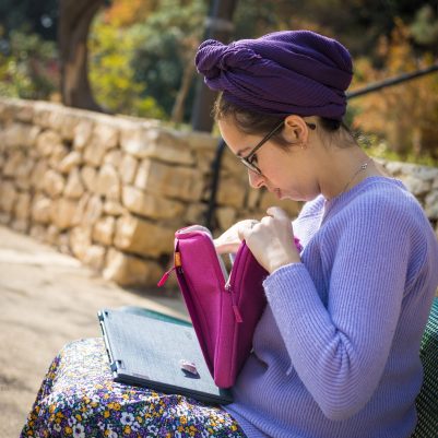 Woman reaching into laptop case