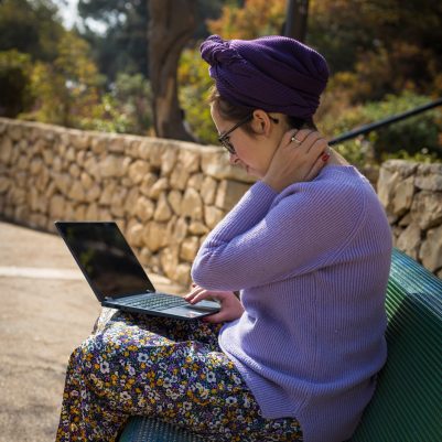 Woman working on laptop in park
