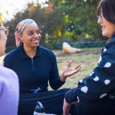 Group of women sitting outside talking 2