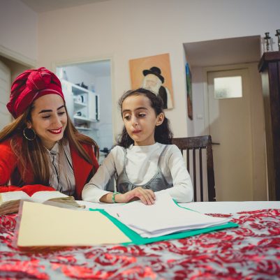 Mother helping daughter with homework