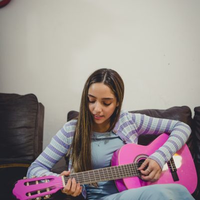Young woman playing guitar 1