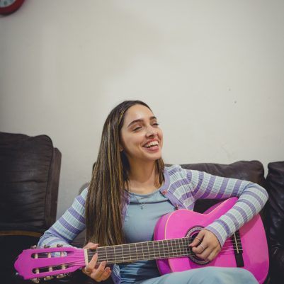 Young woman playing guitar 2