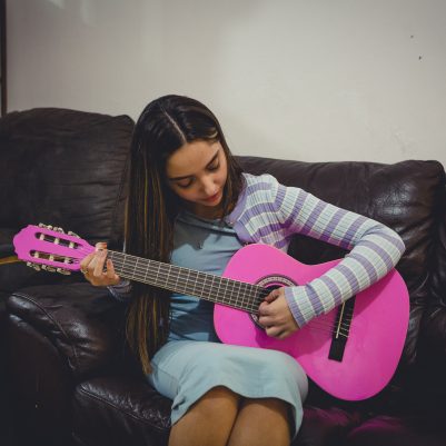 Young woman playing guitar 3