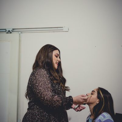 Mother applying makeup on daughter