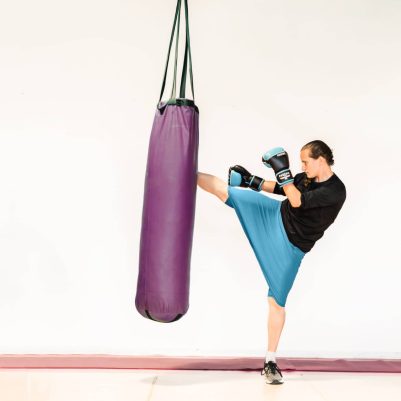 Woman kicking punching bag