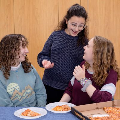 Group of young women eating pizza 1