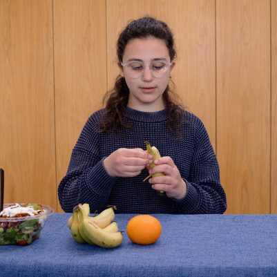 Young woman eating fruit 1