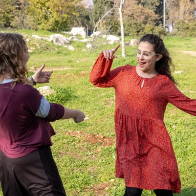 Two young women dancing in park 1