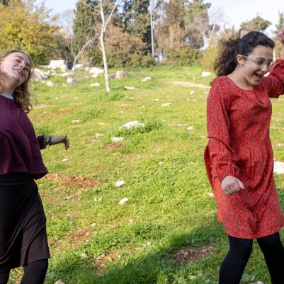 Two young women dancing in park 4