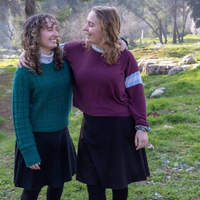 Two young women standing side by side