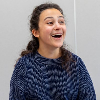 Young woman laughing and looking off to the side