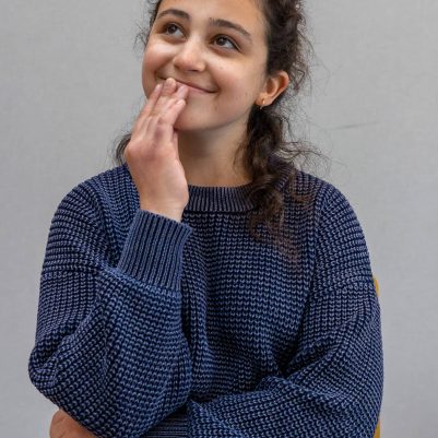 Smiling young woman in thought