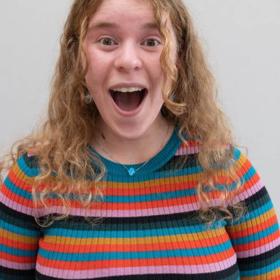 Young woman smiling in surprise