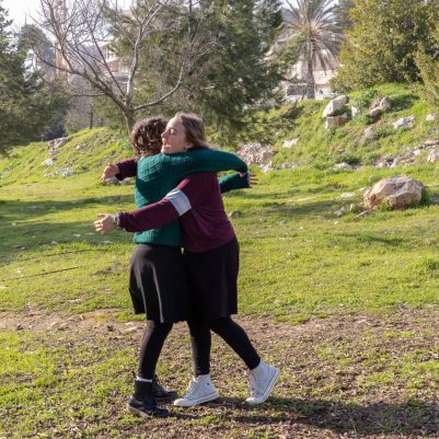 Young women hugging in a park 1