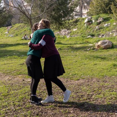 Young women hugging in a park 2