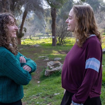 Two young women in conversation outside 5
