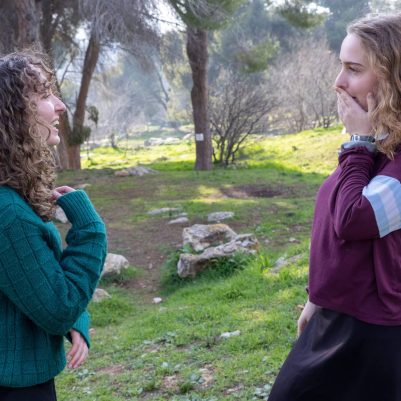 Young woman reacting in surprise to friend talking