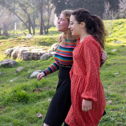 Two young women walking in park 2