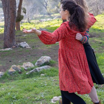 Two young women walking in park 3