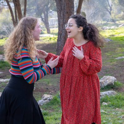 Two young women in conversation outside 5