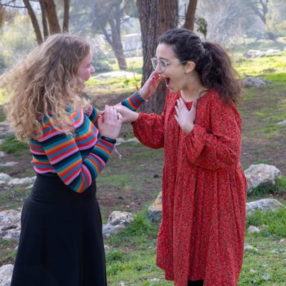 Two young women laughing in park 1