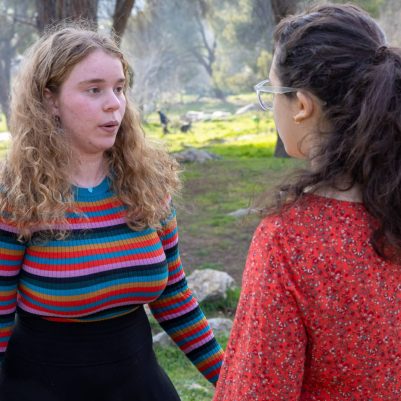 Two young women in serious conversation outside 1