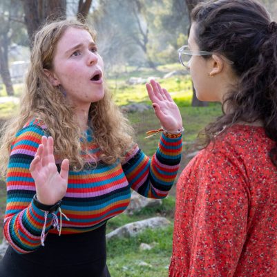 Two young women arguing outside 4