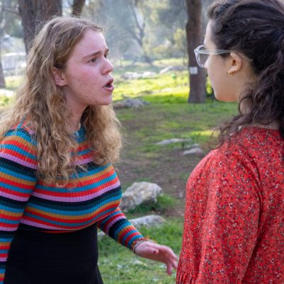 Two young women arguing outside 5