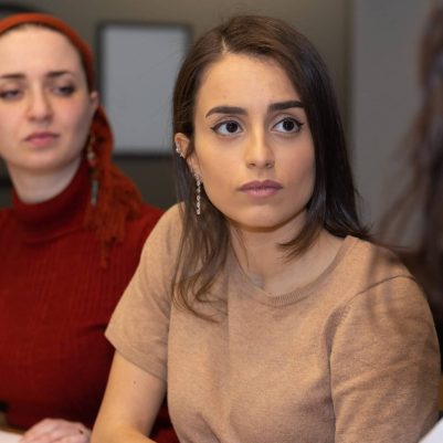 Woman listening to another woman speaking
