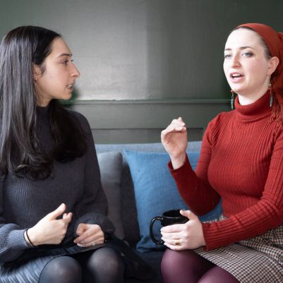 Two women sitting on couch on discussion