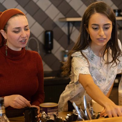 Two women making coffee at office 2