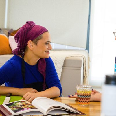 Two women sitting at kitchen table in conversation