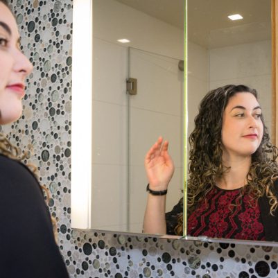 Woman standing in front of mirror