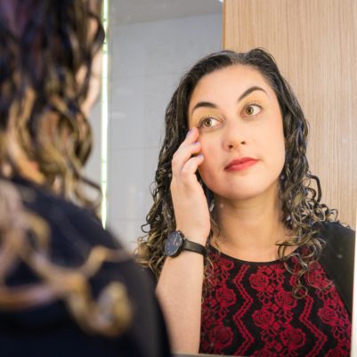 Woman looking at reflection in mirror