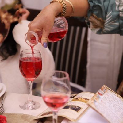 Woman pouring wine at Seder 1
