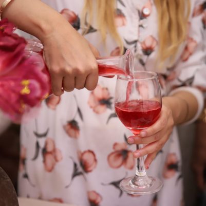 Woman pouring wine at Seder 2