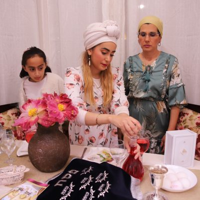 Women standing at Seder table