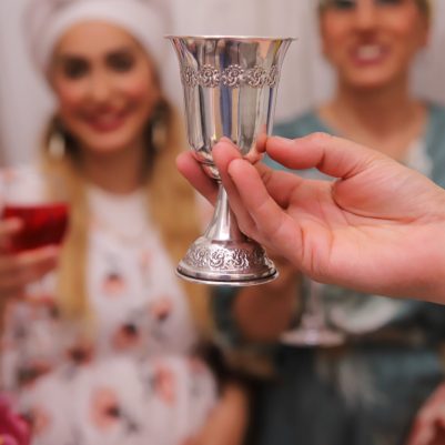 Woman holding cup at Seder